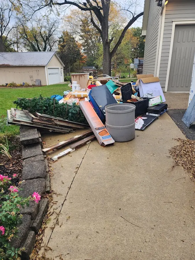 Dumpster being loaded with debris for Estate Cleanout Dumpster Rental in Brentwood